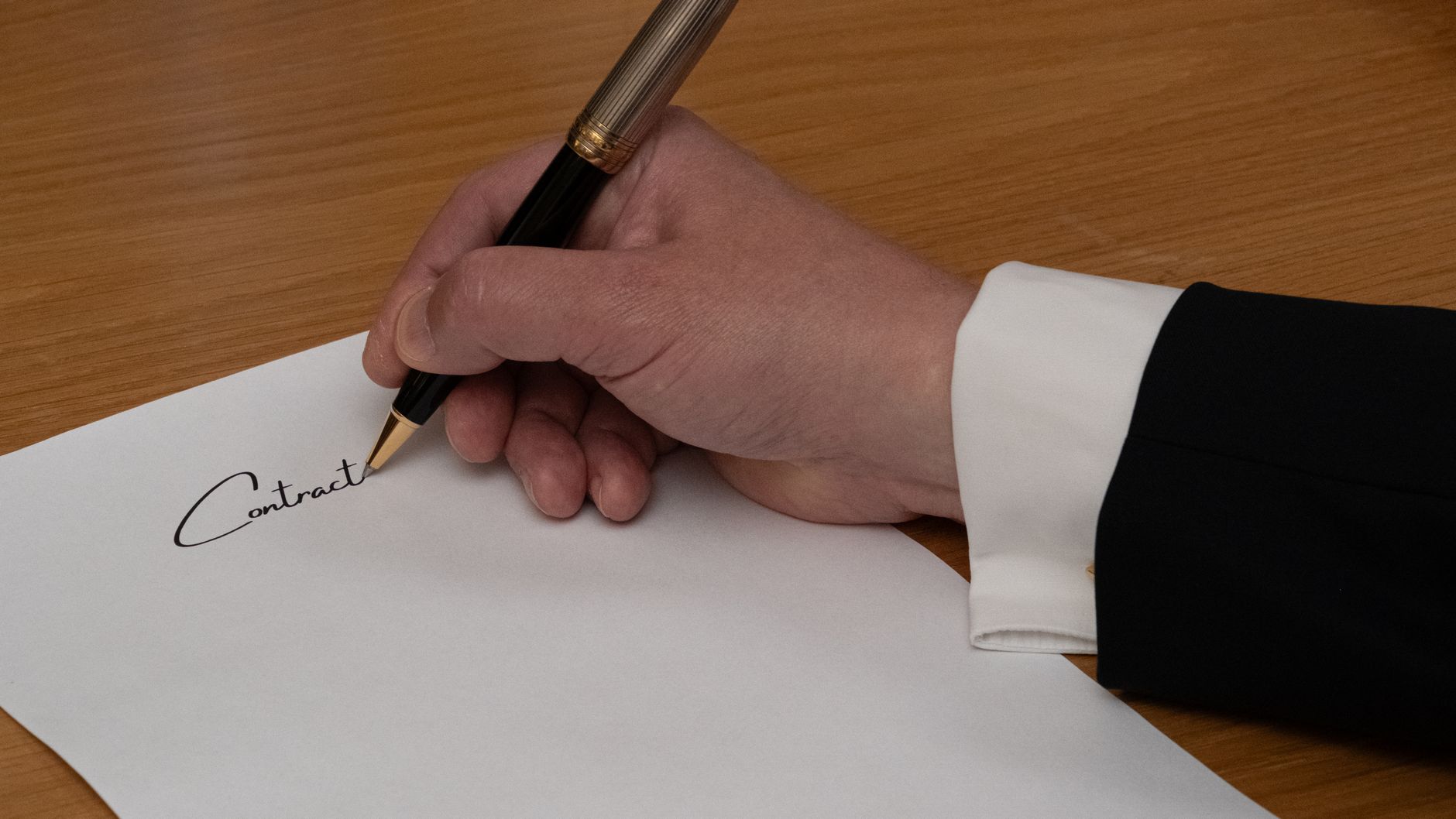 A pen resting on a sheet of paper on a desk.