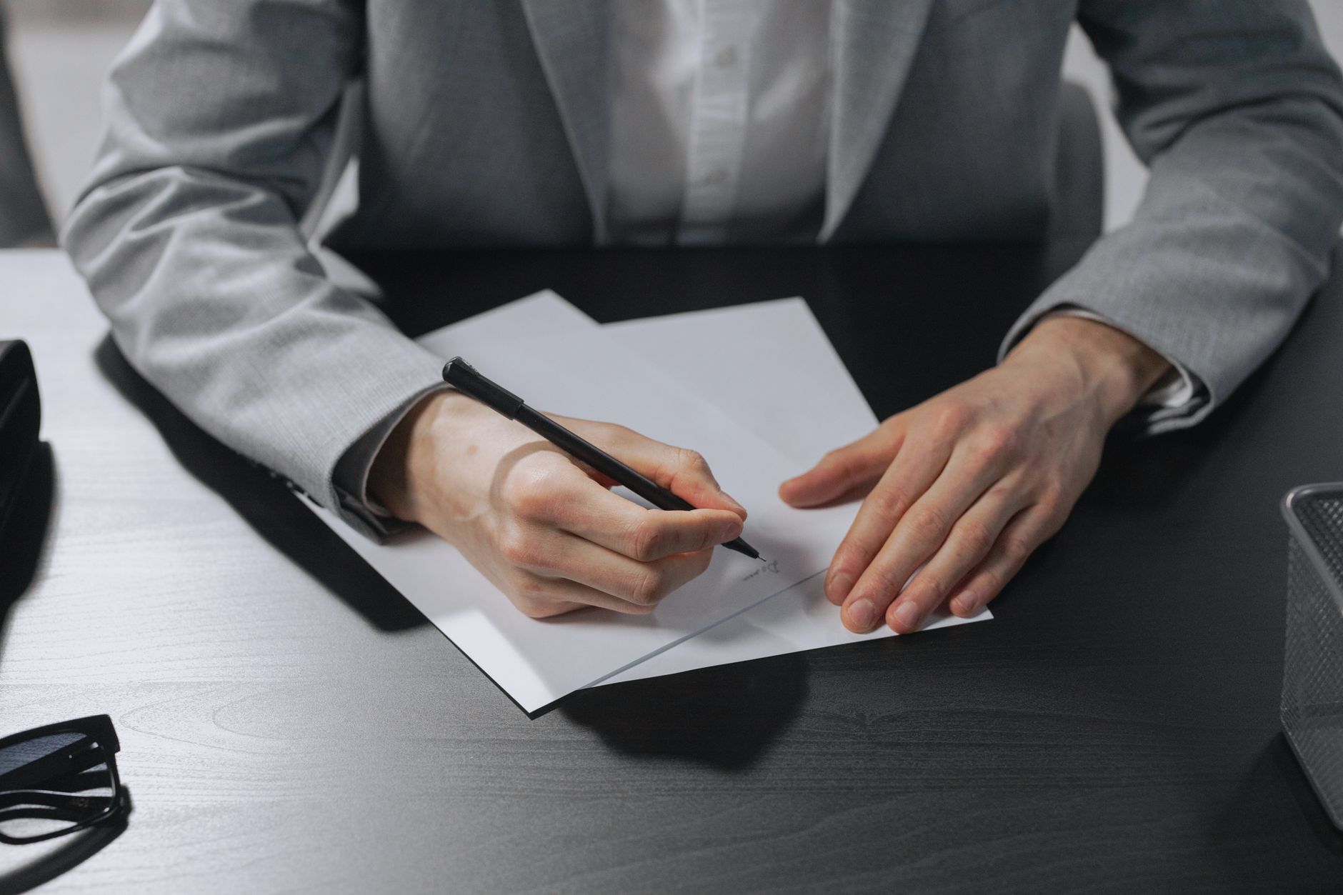 A laptop and a signed document on a home-office desk