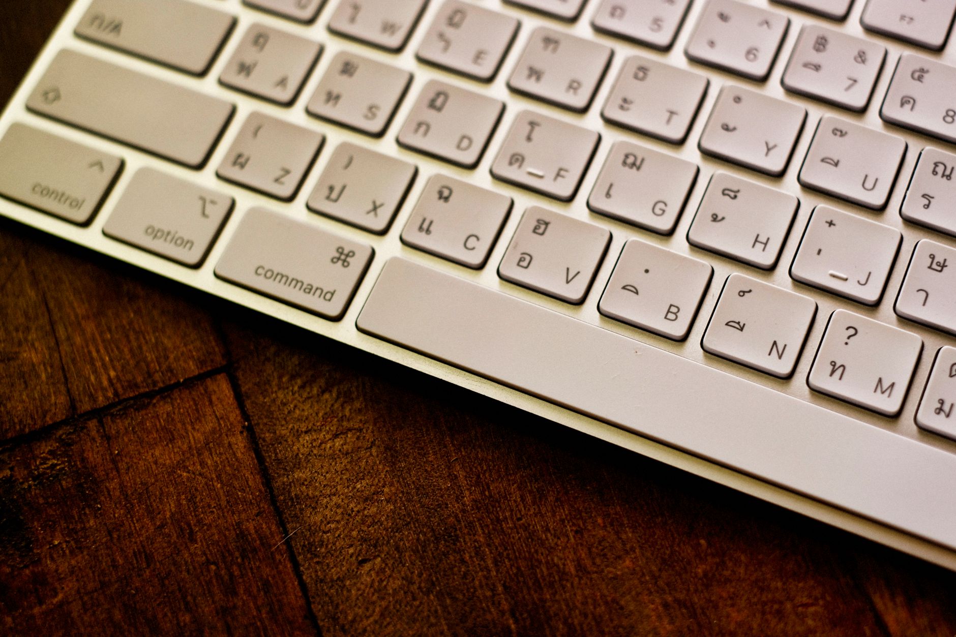 A set of keys beside a closed folder on a desk.