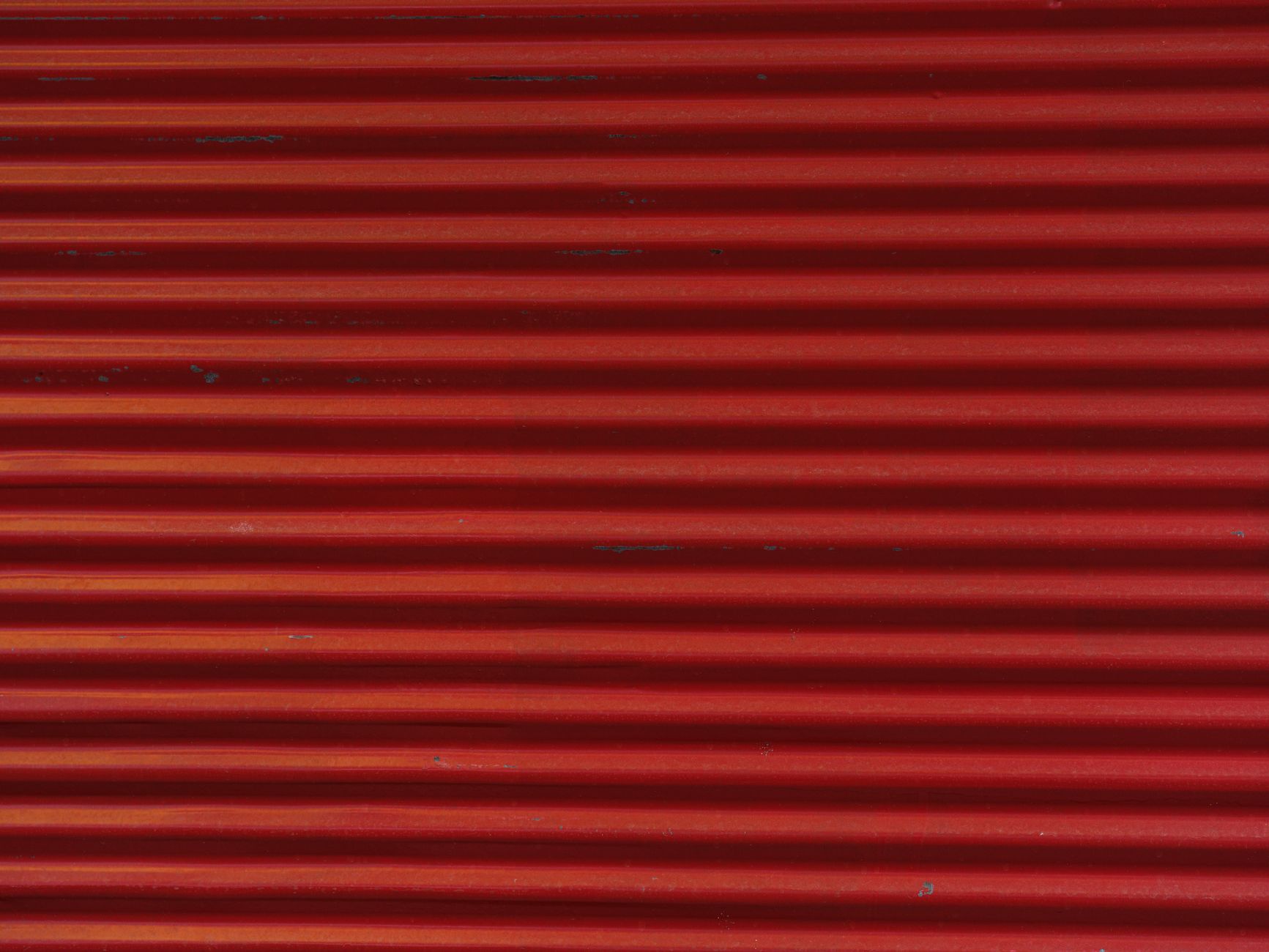 A shop front with its metal shutter pulled down.
