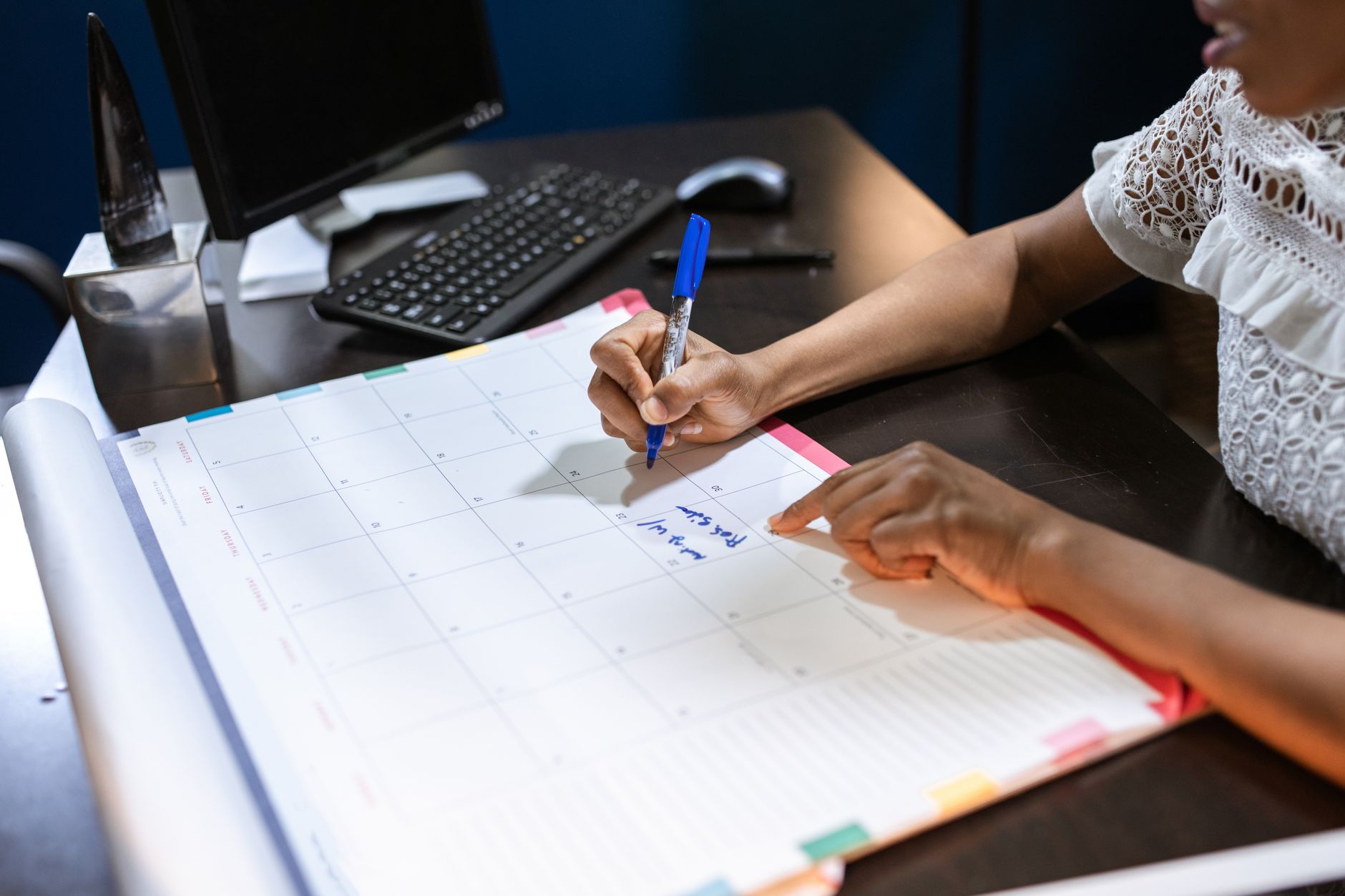 A folder of application documents and a pen on a desk